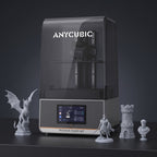 Aura Max resin 3D printer with detailed gray resin prints: a dragon, a knight, a castle tower and a bust