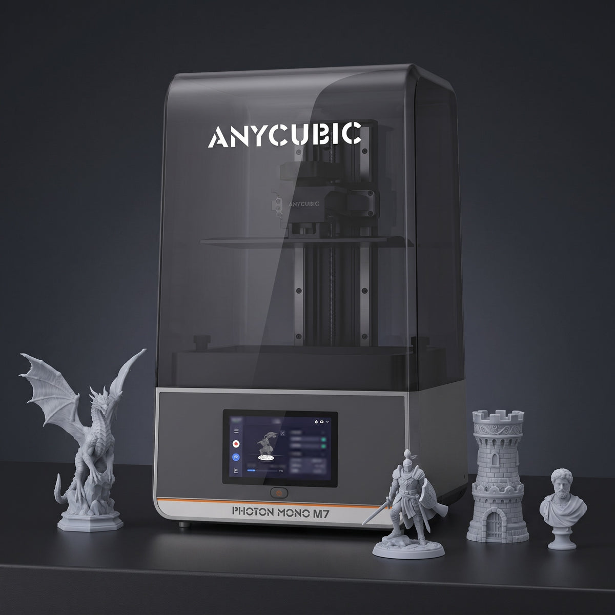 Aura Max resin 3D printer with detailed gray resin prints: a dragon, a knight, a castle tower and a bust