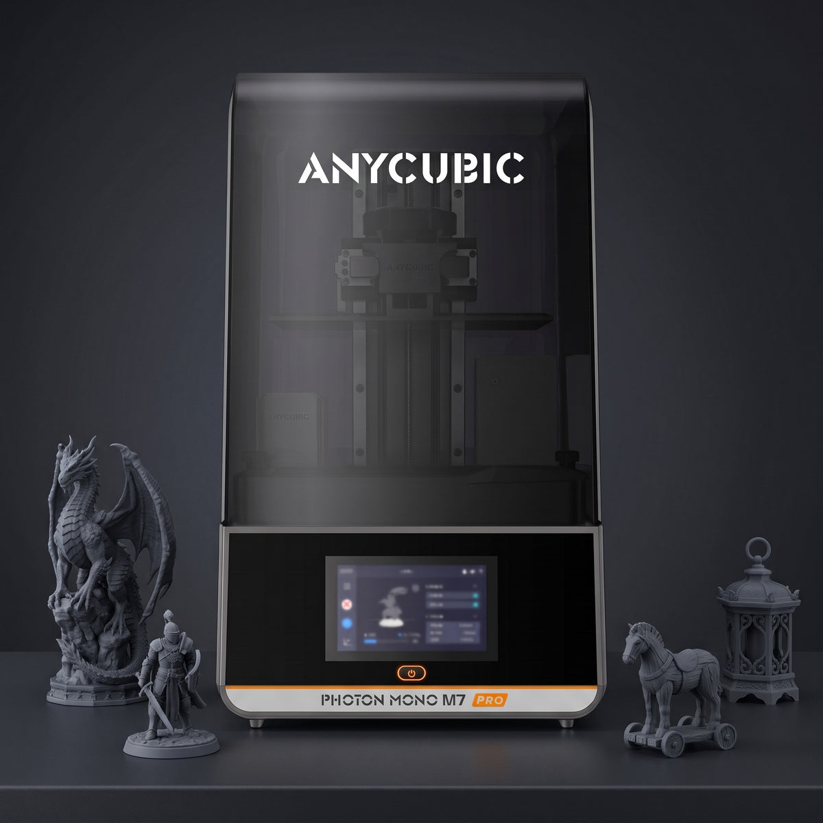 Aura Max Pro resin 3D printer with detailed gray resin prints: a dragon, a knight, a horse on wheels and a lantern
