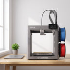 Fusion Multi 3D printer on a light oak desk in a bright home office