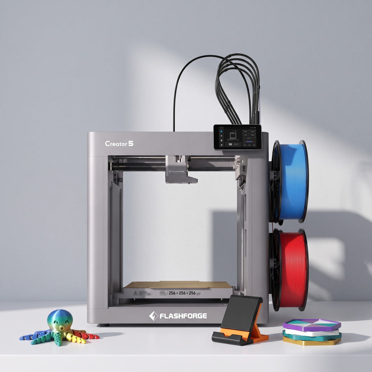 Fusion Multi 3D printer with a multicolor articulated octopus, two-color phone stand and stacked coasters
