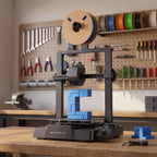 Nova X3 3D printer on a wooden workbench in a maker workshop with calipers and a blue printed part