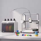 Spark Color 3D printer next to colorful 3D-printed objects