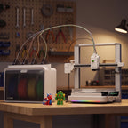 Spark Color 3D printer and filament box on a workbench in a hobby room, RGB light bar on