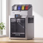 Titan Color 3D printer with filament box on a light oak desk in a bright home office