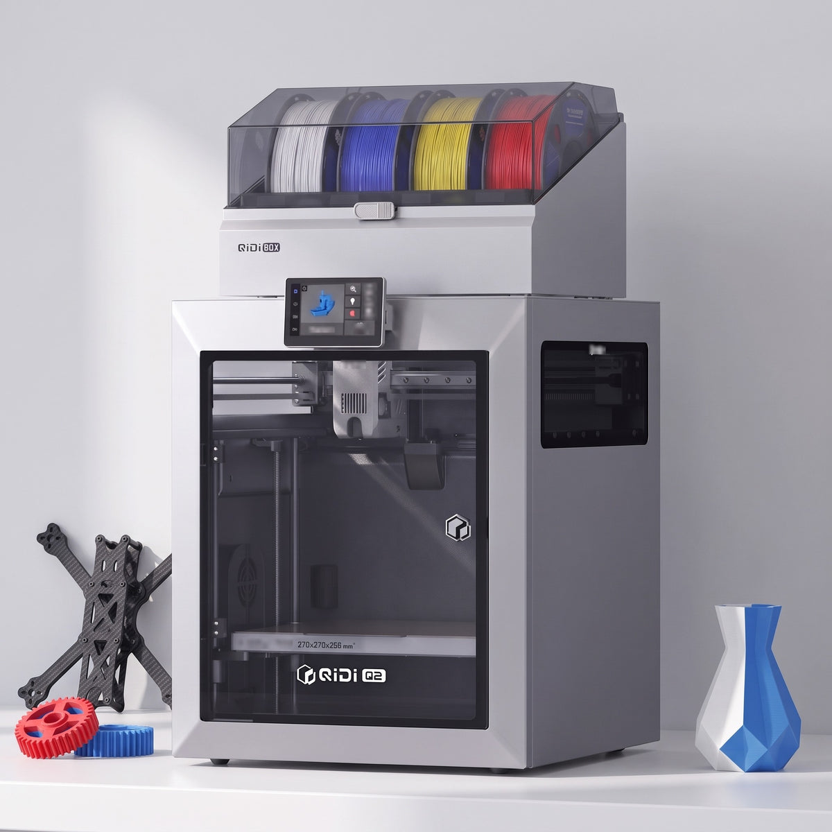 Titan Color 3D printer with a carbon-fiber drone frame, red and blue gears and a two-tone vase