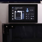 Close-up of the Titan Max Color touchscreen and glass door hinge